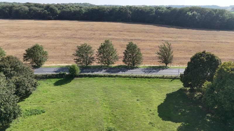 open fields under a wide, pale sky
